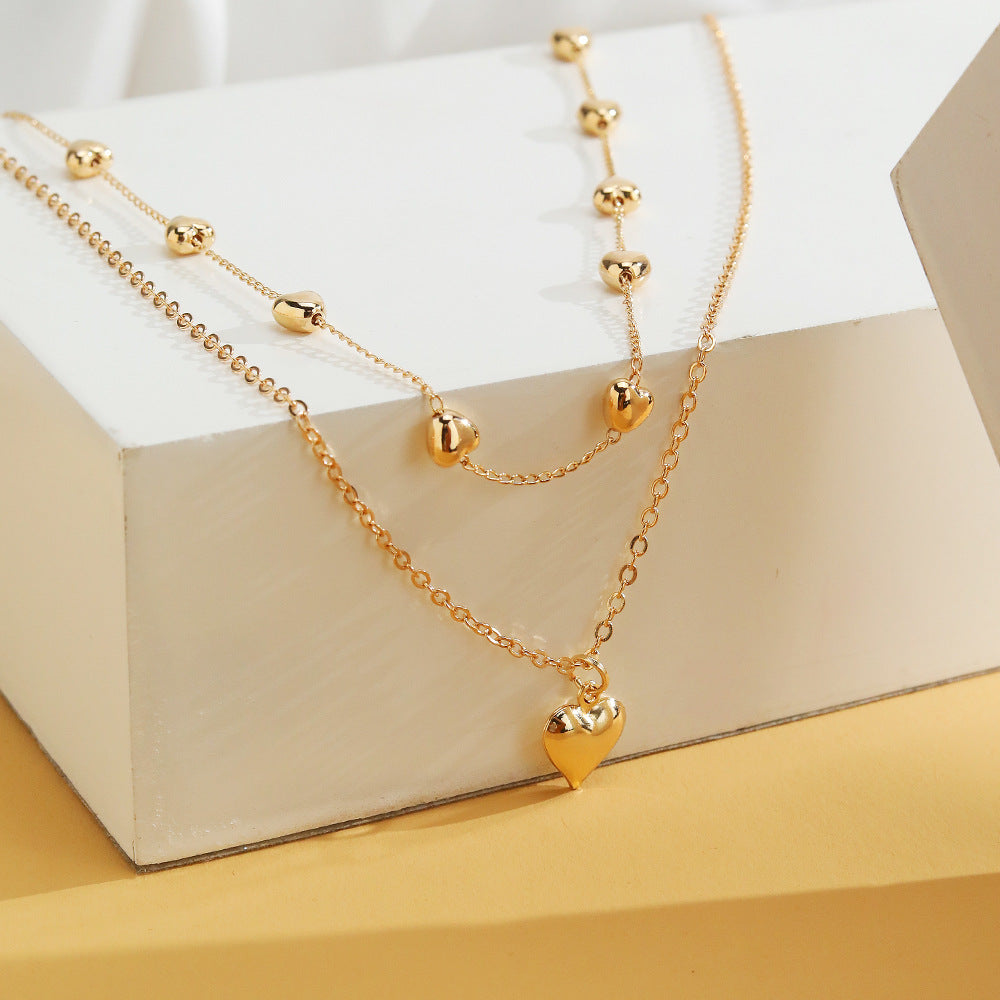 Chaînes dorées à double rang pendentif cœur - StyleNova Paris