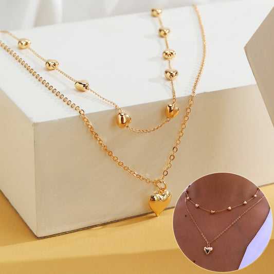 Chaînes dorées à double rang pendentif cœur